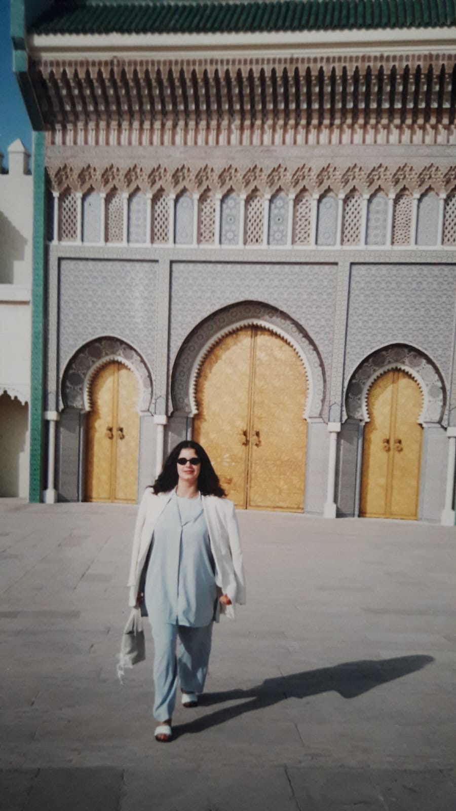 Tourist at a magnificent Moroccan royal palace with golden doors